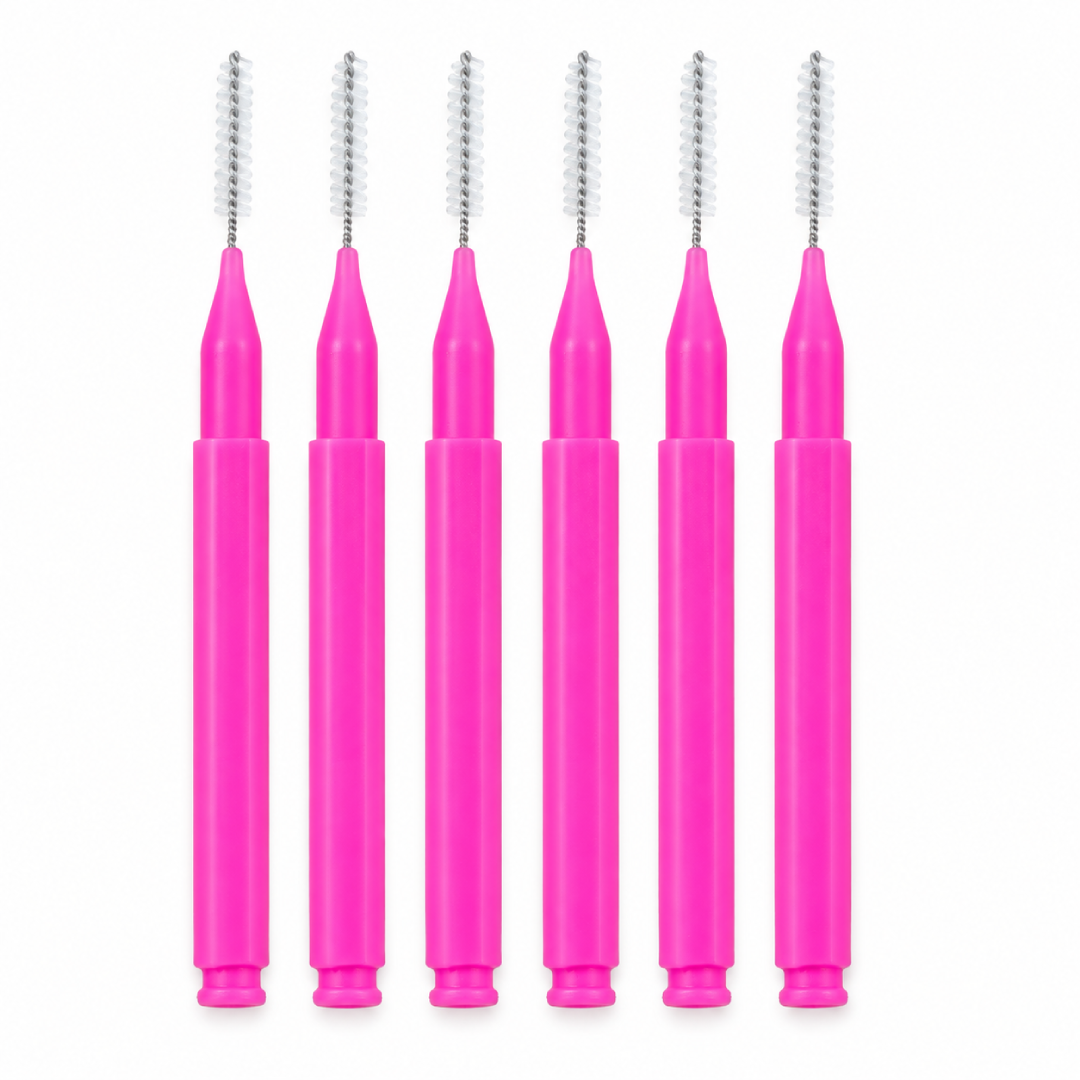 Pink-handled brow comb brushes with slim spiral heads for eyebrow separation and brow lamination styling, shown on a white background.