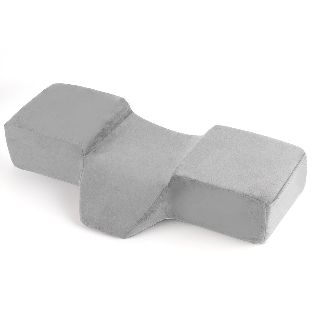 Ergonomic lash pillow with plush velvet cover, zero-pressure support, dual side pockets for tools, holds head steady at ideal working angle.