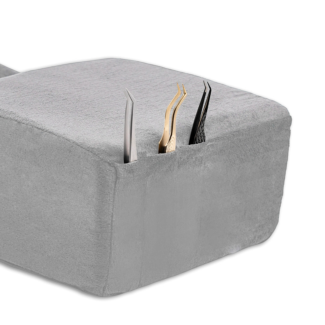 Ergonomic lash pillow with plush velvet cover, zero-pressure support, dual side pockets for tools, holds head steady at ideal working angle.