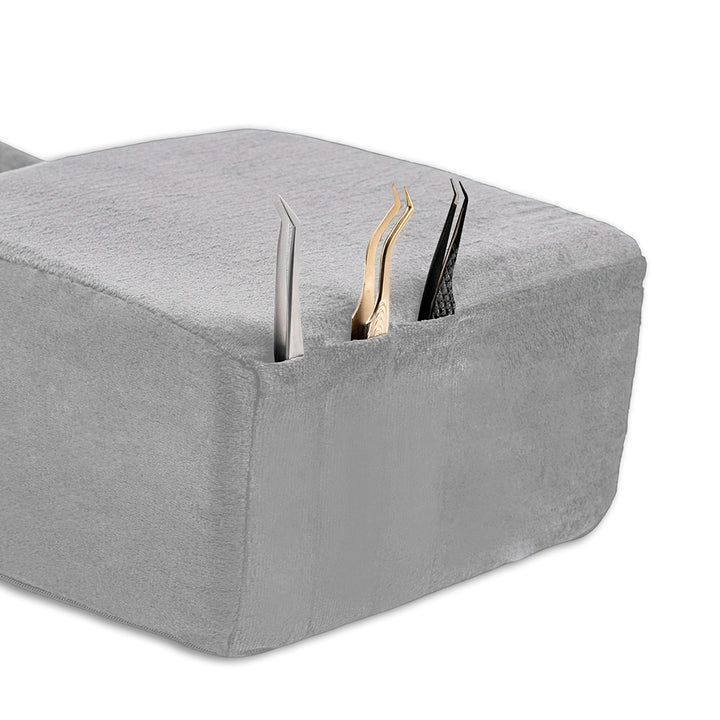 Ergonomic lash pillow with plush velvet cover, zero-pressure support, dual side pockets for tools, holds head steady at ideal working angle.