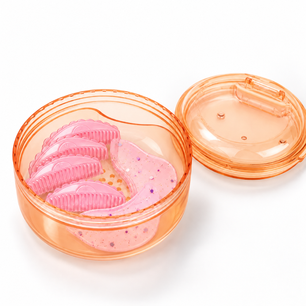 Black and apricot lash lift shield storage and cleaning cases with translucent round bodies and removable lids.