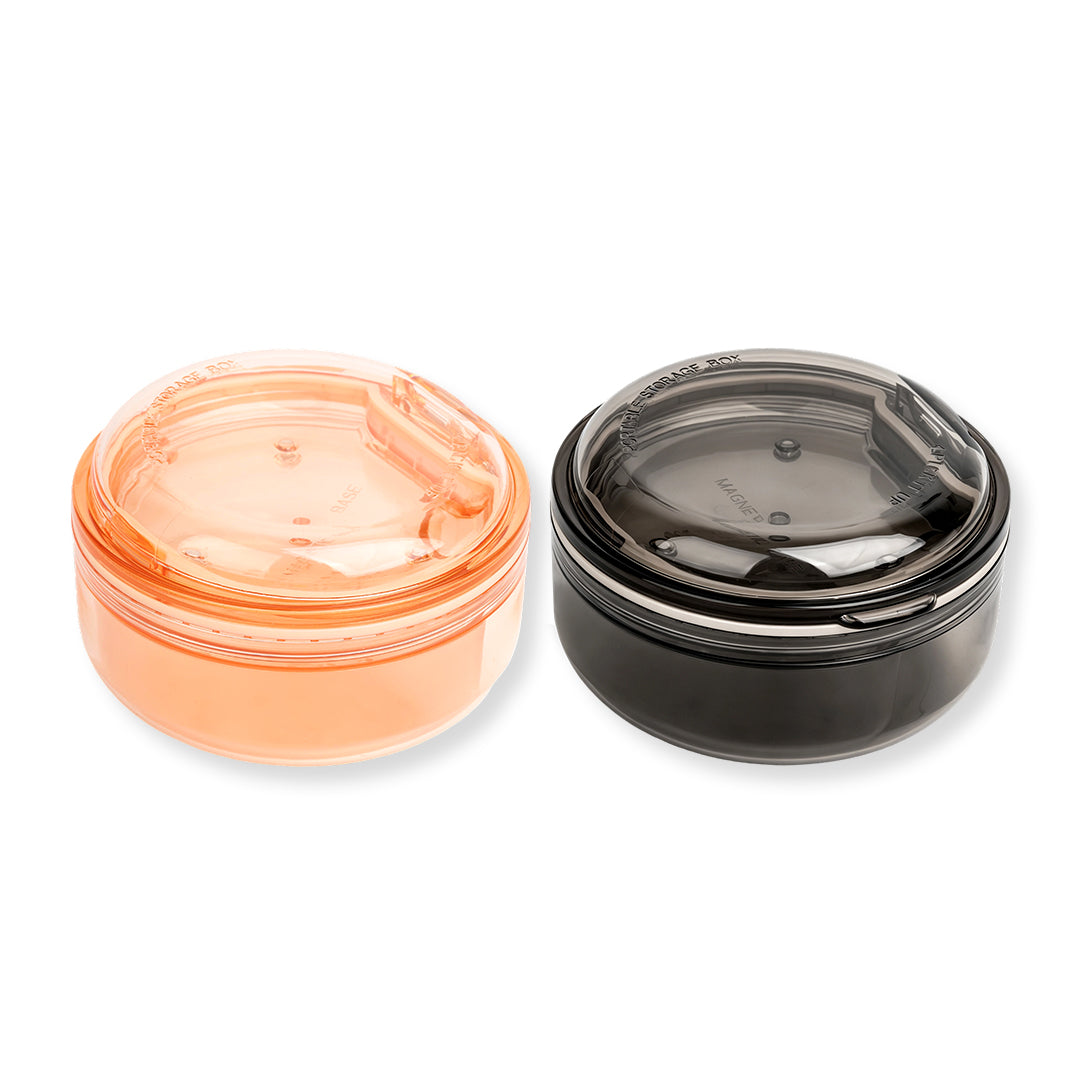 Black and apricot lash lift shield storage and cleaning cases with translucent round bodies and removable lids.