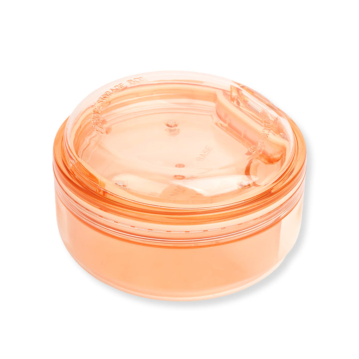 Black and apricot lash lift shield storage and cleaning cases with translucent round bodies and removable lids.