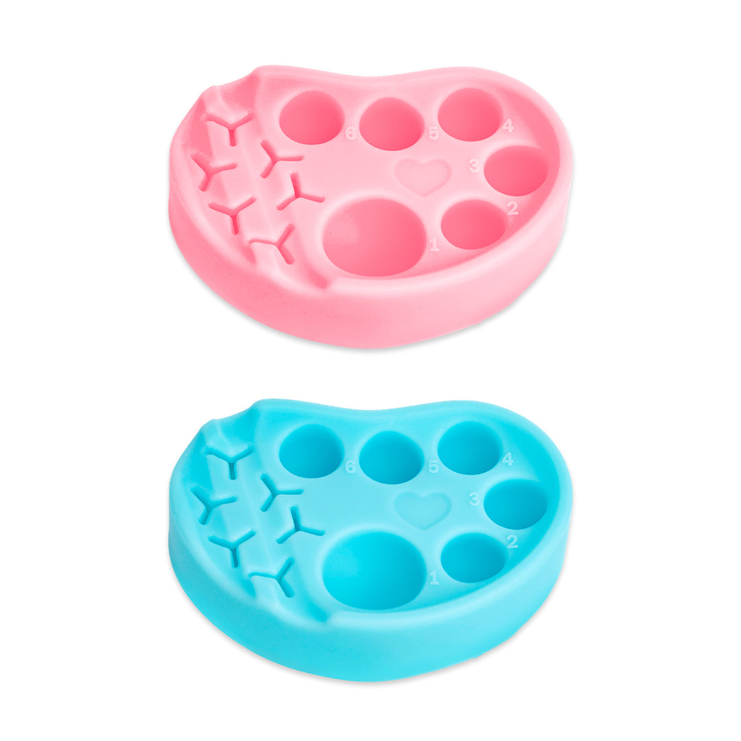 Pink and blue silicone palettes for lash lift and tint, each with six numbered wells and built-in holders for horizontal or vertical tool placement.